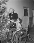William Earl Davis with Eula Hunter, decorating Christmas tree in polio ward