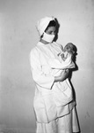 Jacqueline Stewart Keen, infant daughter of Mr. and Mrs. Boyd Roberts Keen, in the arms of Nurse, Nellen Garner.