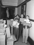 Oakhurst Elementary School students loading stacks of paper