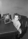 Barbara Ann Boothman, 5, holding picture of her uncle, Roy G. Boothman