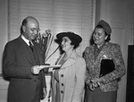 William Holden, executive vice-president of the Fort Worth Chamber of Commerce, presenting check to Mrs. Charles Thomas, left and Mrs. George Seaman