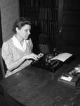 Mrs. Willie Fay Lewis at her typewriter; she is resigning as executive secretary