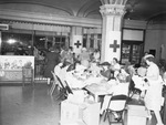 Red Cross workers. Women filling packages for service men