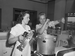 Miss Katherine Bailey directing Mrs. H. D. Garner in proper canning methods
