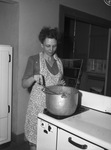 North Side High School canning center. Mrs. John S. Moran stirs chili