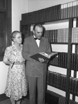 Mrs. B. H. Mothershead, Texas Christian University librarian, and President M. E. Sadler, inspect volume donated to the school by the late Doctor Goodall H. Wooten