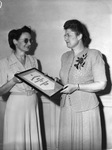 Texas Christian University graduating exercises. Miss Gladys Simons presenting award to Miss Elizabeth Shelburne, dean to women at Texas Christian University