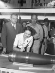 Shell Day. President Warren Wells of American Manufacturing watches as Mrs. Naomi A. Clay writes her name on a shell. Standing behind is J. C. McAlister