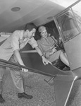 John Andrus, seventeen, receiving instrument panel explanation from Lieutenant Verna Burns