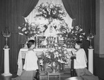 Saint Patrick's Catholic Church. Tommy Reynolds, left, and Jack Jackson, altar-boys, praying before a beautifully decorated altar