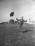 Arnie Feeler, 8 year old boy flying a kite by Tom Dillard