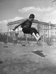 High School student, practicing a broad jump by Tom Dillard