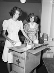 Red Cross. Gift packing. Jackie Forman (left) and Justine Digby-Roberts, placing small boxes in a carton