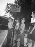 School children shown with traffic sign