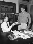 United States Constitution Quiz Contest Gene Roberts, right of Masonic Home, receiving textbook from H. A. Wilson, history teacher