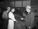 George T. Christopher, president of Packard Motor Car Company, right, Eugene Brooks, center, and Ray H. Eisele, left Fort Worth Packard dealer