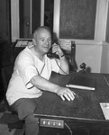 Dr. Phil Russell talking on telephone