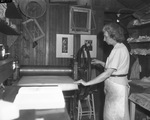 Blanche McVeigh operates the press she uses to make prints and aquatints