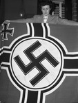 Mrs. G. E. Wheeler, holding a Nazi flag