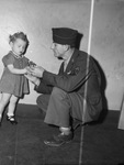 Catherine LaVerne Rahr, selling poppy to her father, Sergeant Glenn D. Rahr