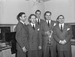 Jan Garber band musicians. Left to right, Jack Motch, pianist of Amarillo, Texas; Herb Ellie from McKinney, Texas; Bob Davis, vocalist from Fort Worth, Texas and Bill Kleeb of Kilgore, Texas. Jan Garber is at the right.