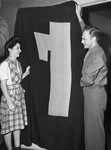 Private J. K. Chancy and his bride display the 18-foot Italian fascist flag