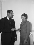 Parker Willson, left, handing a check to Mrs. Ethel Burch for day room at United States Public Health Service Hospital
