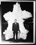 Copy of photos of C. R. Smith standing in front of bear skin.