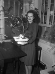 Mrs. Alfred McKnight Junior shown with flower arrangement.