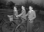 The Sitton triplets, Royce, Richard and Robert, on their bicycles.