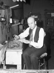 Joseph S. Edelbrock II, saddle-maker, at work at his bench