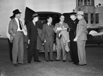 Amon Carter and a group of men in front of a police patrol wagon
