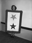 Miss Betty Jo Gamble, Dallas, shown with new Texas Christian University Service Flag
