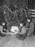 Service Men's Center Christmas Tree. Boy Scouts placing gifts on tree