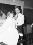 Nellie Conley of the All Church Home having her hair cut by Foy S. Babb.