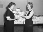 Mrs. C. D. Pemberton and Mrs. C. O. Vinnedge preparing gifts for Service Men's Center