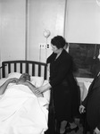 F. E. Kelley in hospital bed, and Mrs. Kelley
