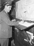 W. A. Chappelear, bus driver, signing the "in-and-out" sheet