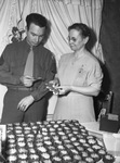 Mrs. Bernice B. Maxfield showing favors to her brother, Sergeant W. C. Miller Junior.