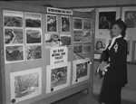 Mrs. Carl Edwards of Tyler, Texas inspecting display at Texas and Southwestern Photographers Association convention