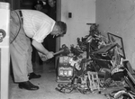 H. W. Carter smashing slot machines confiscated by vice squad and patrolmen