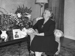 Mrs. J. B. Holmes, looking at Easter flowers