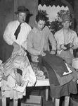 Used Clothes collection. Sorting clothing are George B. Miller, left, Norman Sparks, center, J. R. Roach