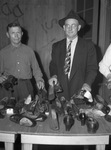 Used Clothes collection. Marking shoes, Ira Cates, left, and W. C. Deaigh