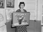 Mrs. Birdie Borden holding her prize winning painting