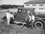 R. L. Henderson, Major H. H. Glazner, C. R. Raynes and Fire Chief Killian of the local force, shown with fire truck from Jacksboro, Texas
