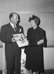Station Manager Clyde Pemberton of KFJZ presenting photo to Mrs. O. G. Mills