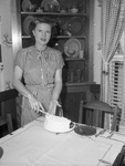 Mrs. T. E. Myers cutting cake
