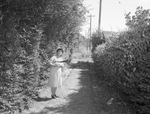 City cleanup campaign. Mrs. Elsie M. Wheeler in well kept alley
