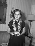 Miss Zoan Denman wearing lei of orchids